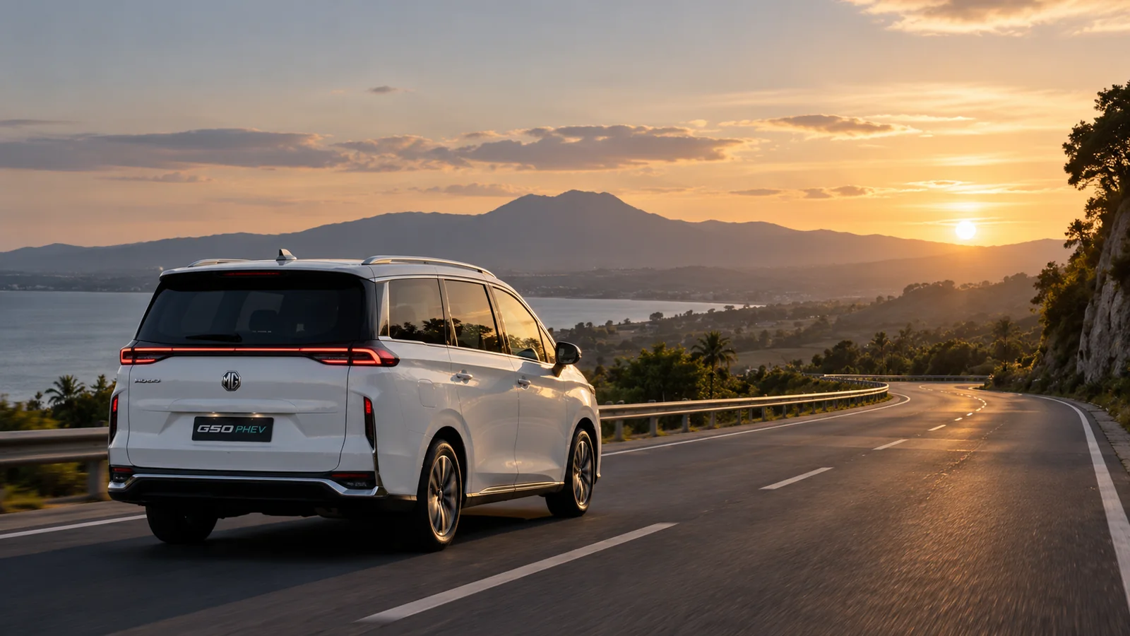 White MG G50 PHEV on a scenic coastal road at sunset